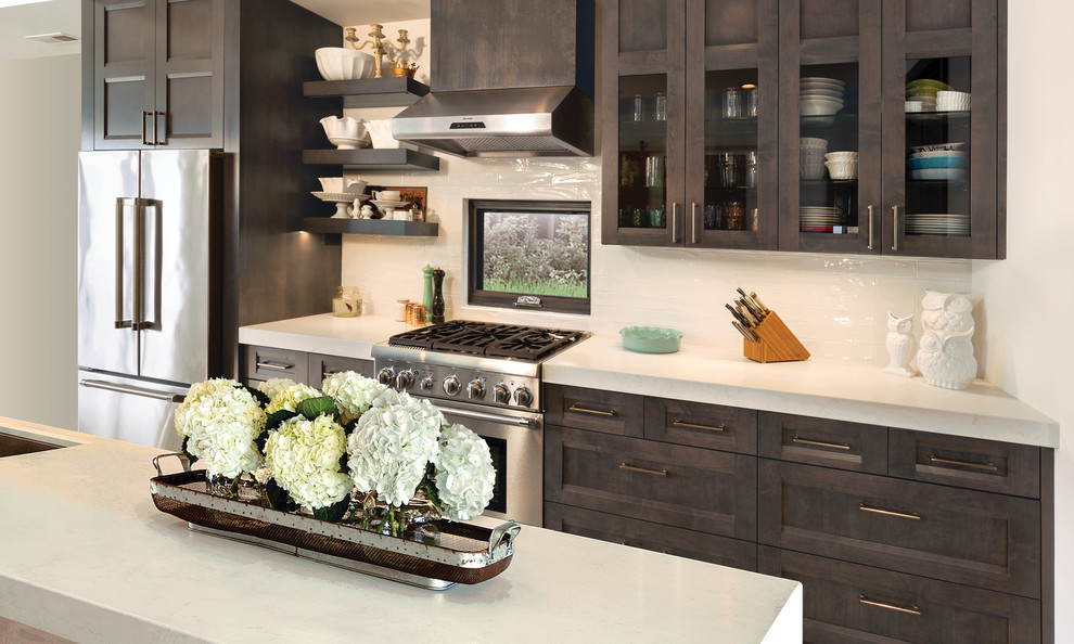 Example of a minimalist kitchen design with dark wood cabinets and stainless steel appliances