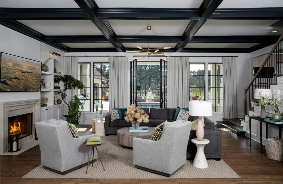 Mid-sized transitional formal open concept living room in Atlanta with white walls, medium hardwood floors, a standard fireplace, a stone fireplace surround, a wall-mounted tv, brown floor and coffered.