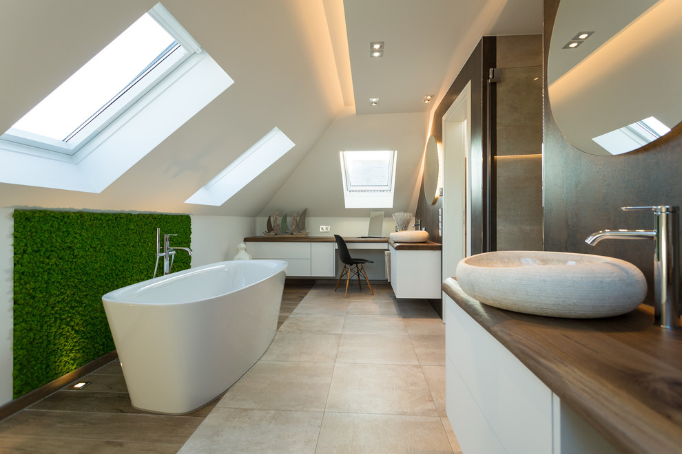 This is an example of a large contemporary 3/4 bathroom in Dresden with flat-panel cabinets, white cabinets, a freestanding tub, an alcove shower, brown tile, cement tile, white walls, cement tiles, a vessel sink, wood benchtops, beige floor and a hinged shower door.