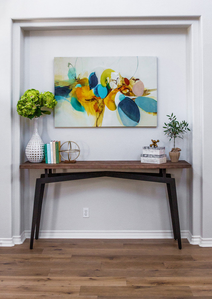 This is an example of a mid-sized traditional foyer in Orange County with grey walls, light hardwood floors and beige floor.