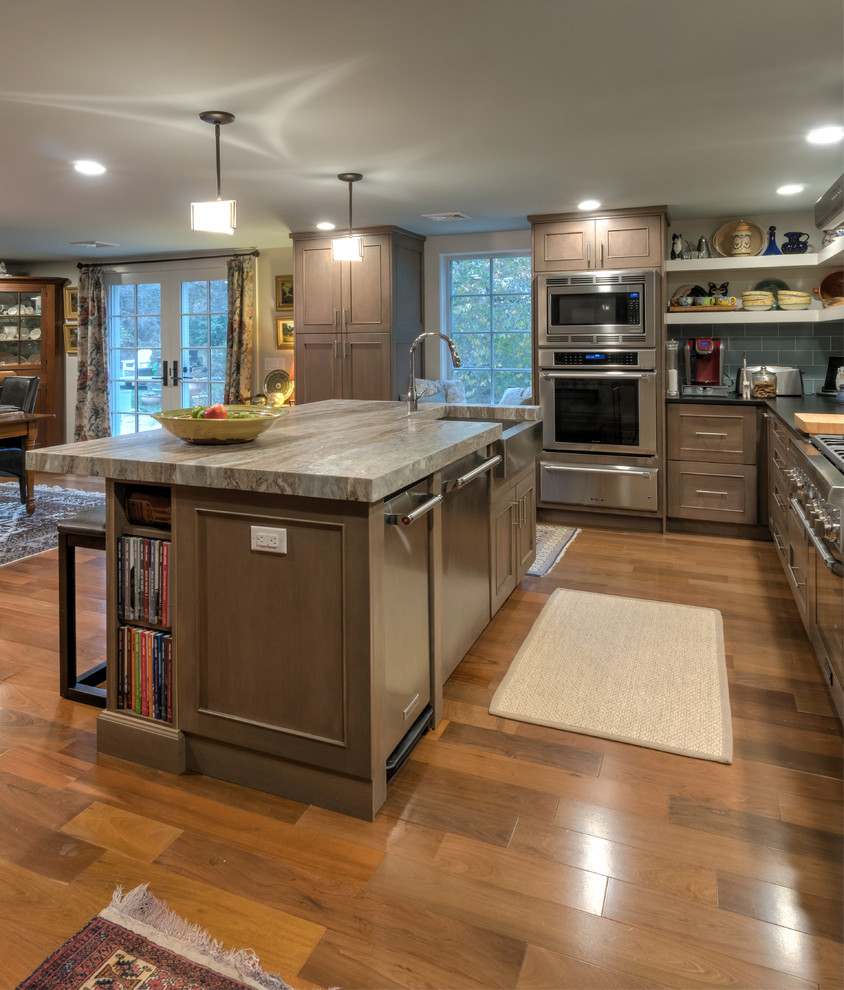Inspiration for a large arts and crafts l-shaped eat-in kitchen in Boston with an integrated sink, recessed-panel cabinets, grey cabinets, granite benchtops, blue splashback, ceramic splashback, stainless steel appliances, light hardwood floors, with island and brown floor.