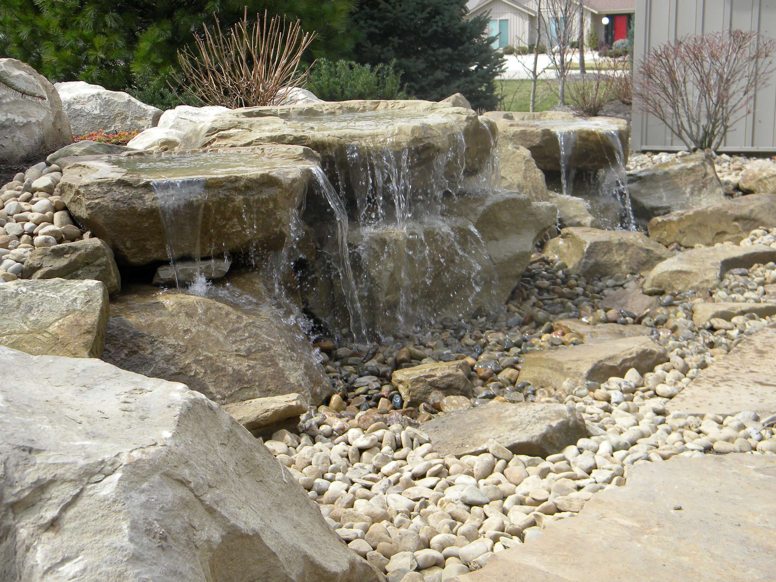 Carved stone water feature pondless and stone patio