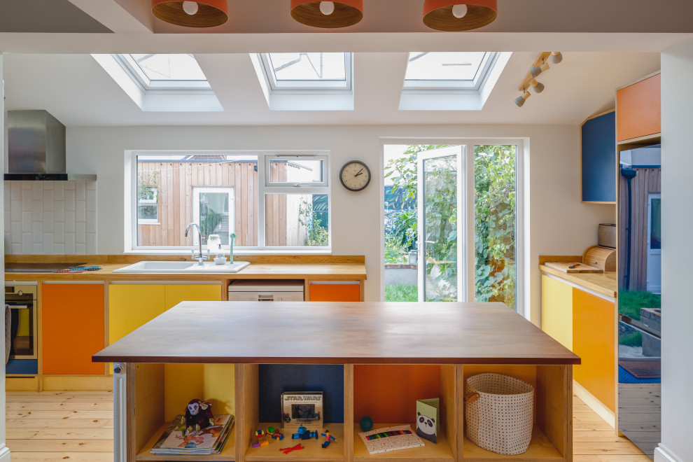 Photo of a modern kitchen with painted wood flooring.