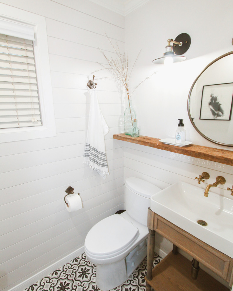 This is an example of a small country 3/4 bathroom in Dallas with furniture-like cabinets, light wood cabinets, a one-piece toilet, black and white tile, white walls, ceramic floors, a pedestal sink, white floor and white benchtops.