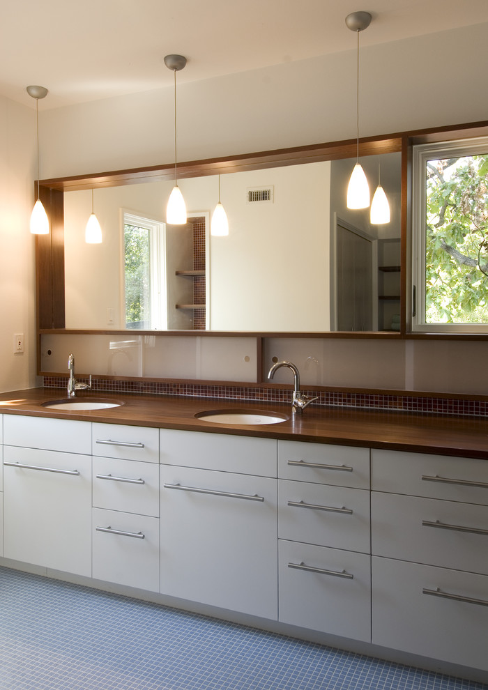 Mid-sized modern master bathroom in Austin with wood benchtops, flat-panel cabinets, white cabinets, blue tile, brown tile, mosaic tile, beige walls, mosaic tile floors, an undermount sink, blue floor and brown benchtops.