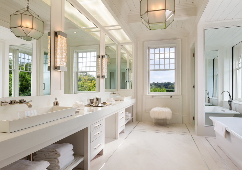 This is an example of a transitional master bathroom in New York with open cabinets, white cabinets, a freestanding tub, white walls and a vessel sink.