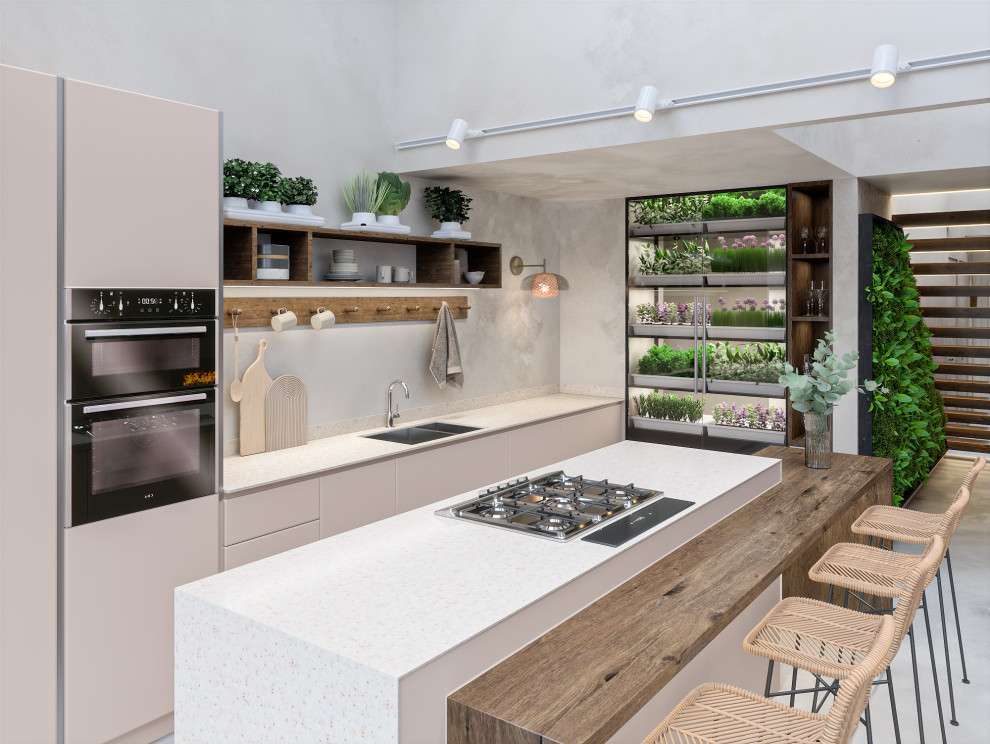 Inspiration for a mid-sized single-wall open plan kitchen in London with an undermount sink, flat-panel cabinets, beige cabinets, solid surface benchtops, stainless steel appliances, concrete floors, with island, grey floor and beige benchtop.
