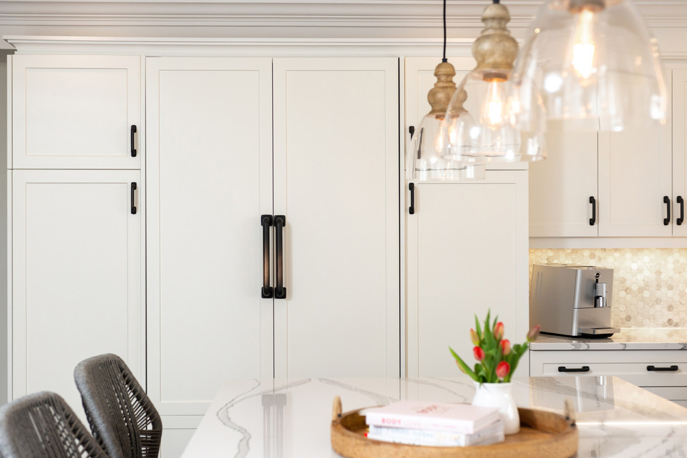 Transitional dark wood floor and brown floor kitchen photo with white cabinets, quartz countertops, paneled appliances, an island and white countertops