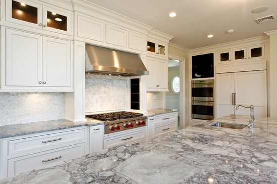 Photo of a large traditional eat-in kitchen in Other with a farmhouse sink, raised-panel cabinets, stainless steel cabinets, granite benchtops, stainless steel appliances and with island.