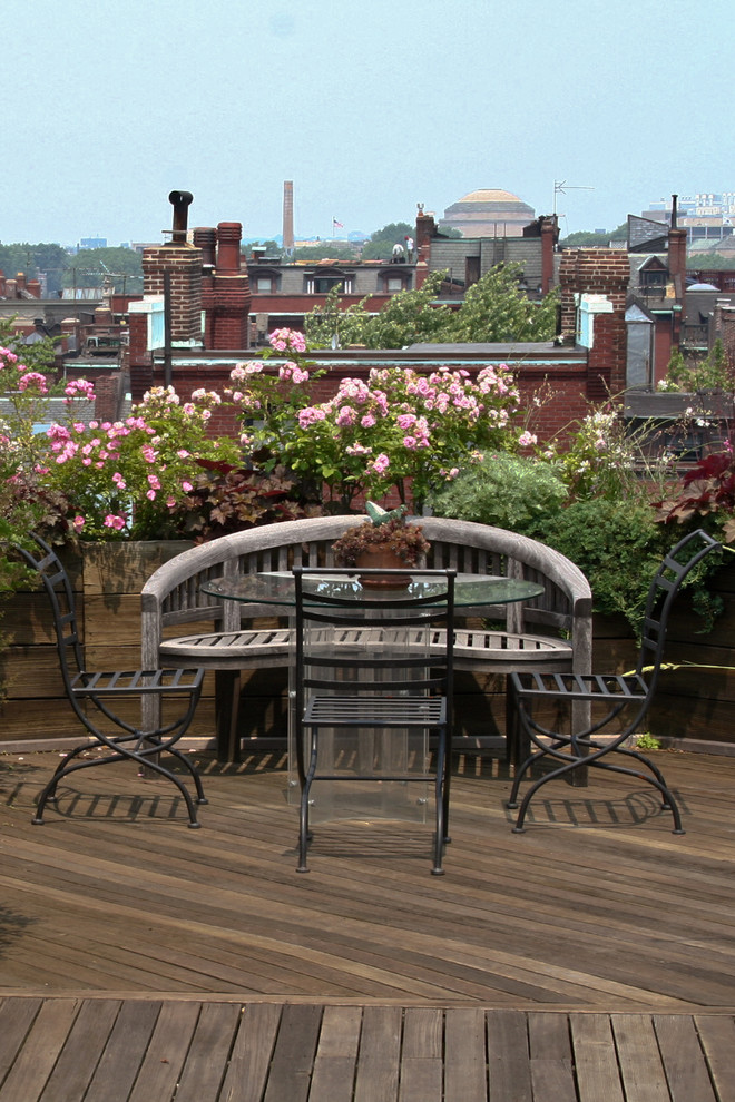 Eclectic rooftop and rooftop deck in Boston with no cover.