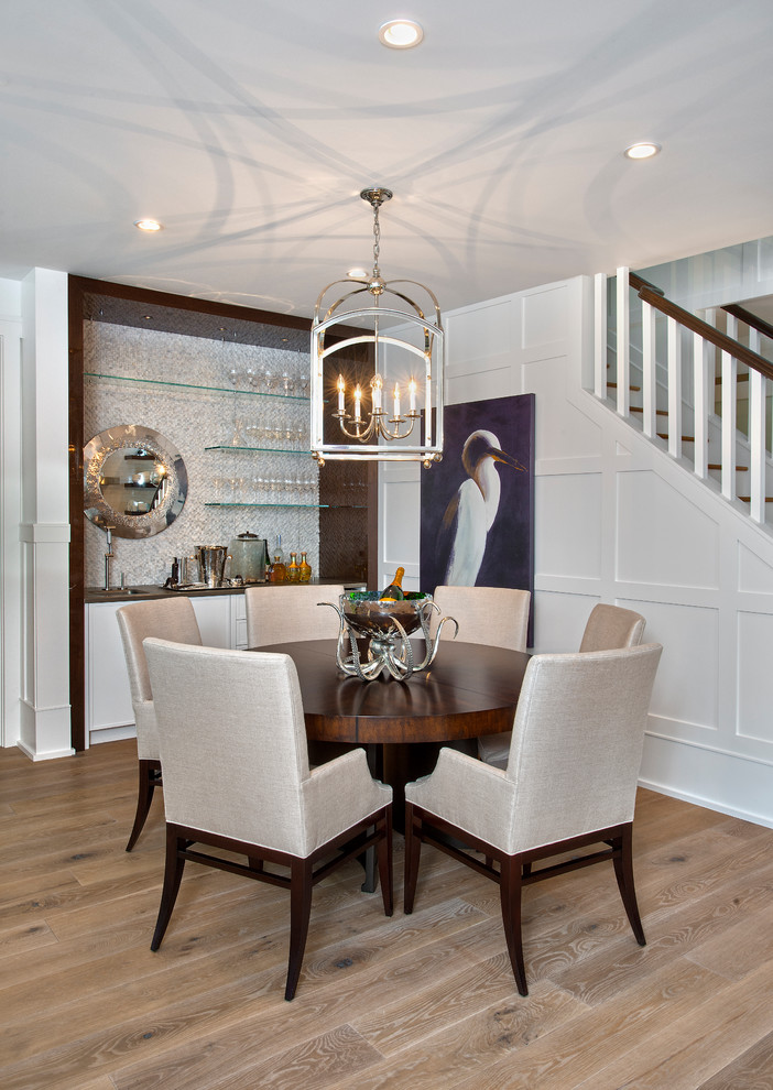Beach style dining room in Miami with white walls, light hardwood floors and no fireplace.