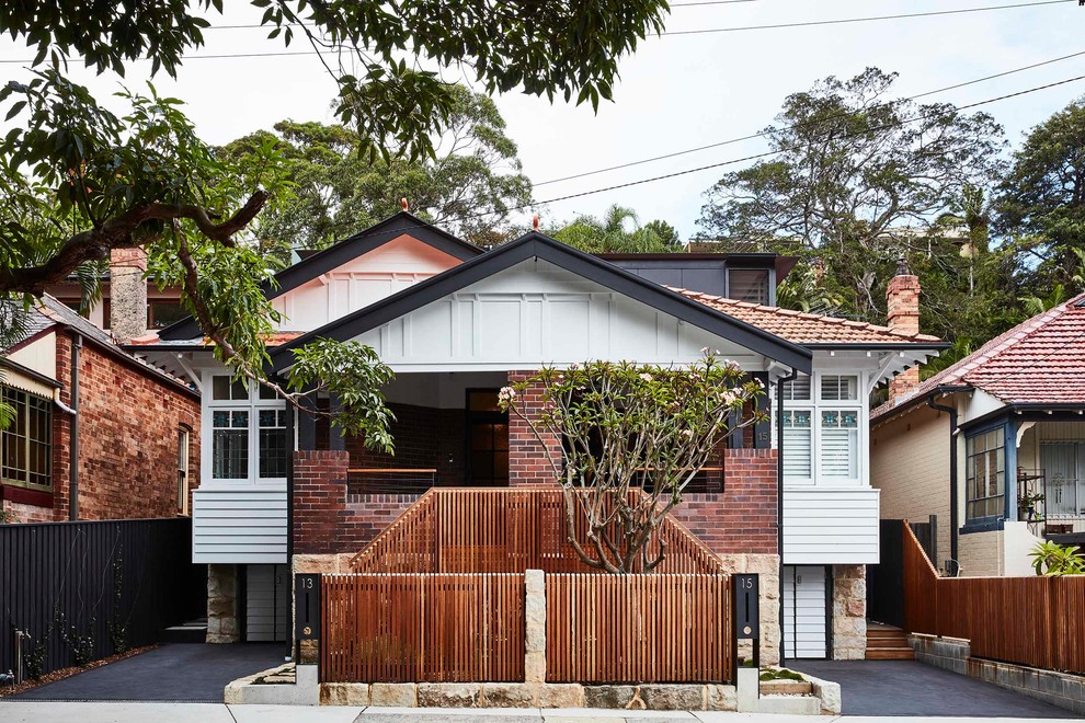 Design ideas for a mid-sized contemporary two-storey brick white townhouse exterior in Sydney.