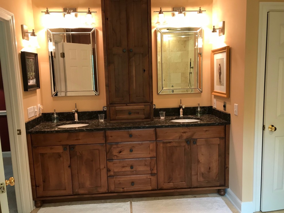 Transitional bathroom photo in Chicago with flat-panel cabinets, medium tone wood cabinets and black countertops