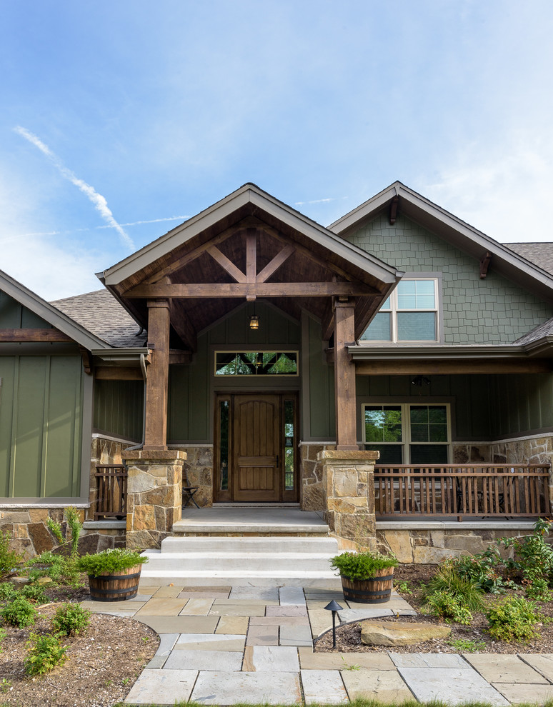 Large mountain style green two-story concrete fiberboard exterior home photo in Chicago