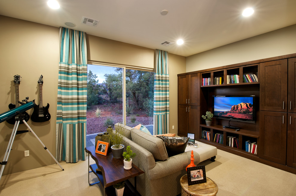 This is an example of a transitional enclosed family room in Phoenix with beige walls, carpet and a built-in media wall.