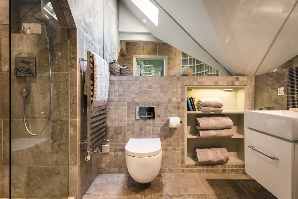 Mid-sized contemporary bathroom in Other with flat-panel cabinets, white cabinets, an open shower, a one-piece toilet, beige tile, ceramic tile, beige walls, ceramic floors, a wall-mount sink, beige floor and a sliding shower screen.