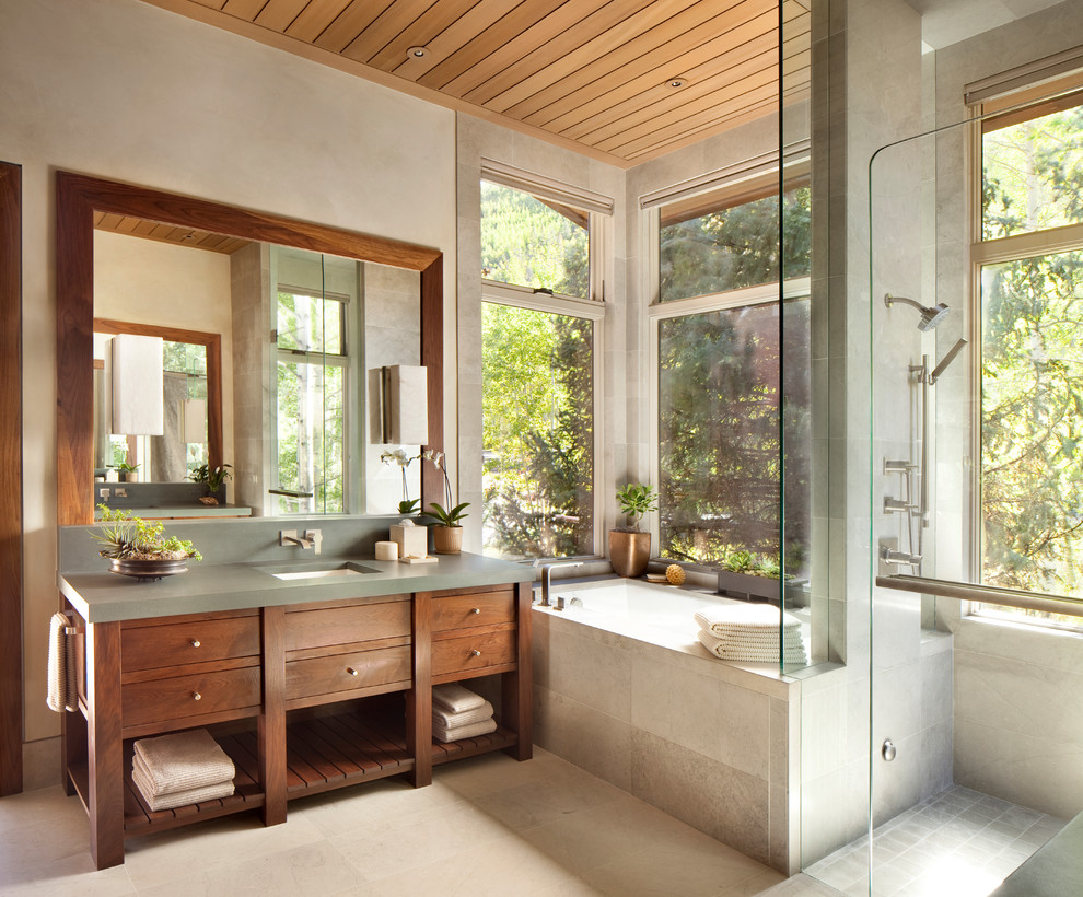 Inspiration for a contemporary master bathroom in Denver with flat-panel cabinets, medium wood cabinets, an undermount tub, a curbless shower, grey walls, an undermount sink, beige floor and grey benchtops.