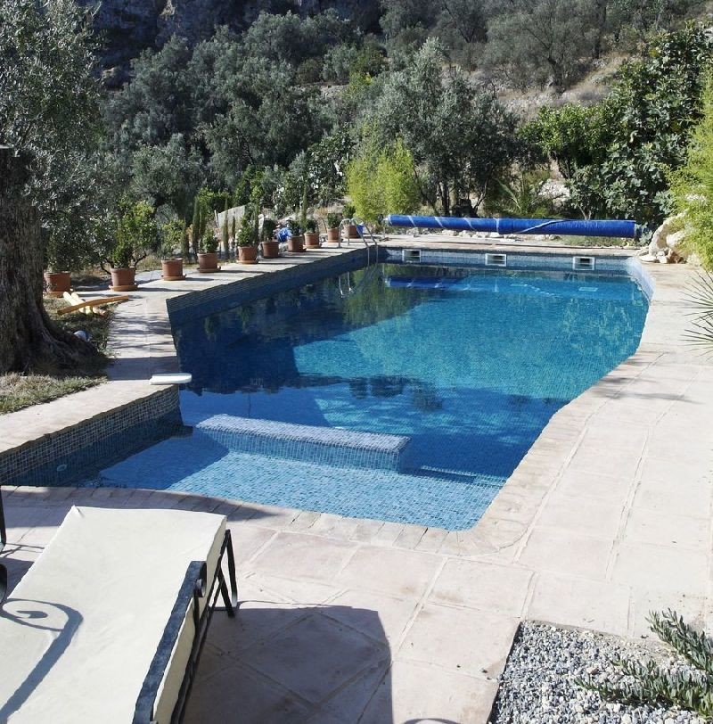 This is an example of a large custom-shaped pool in Other with tile.