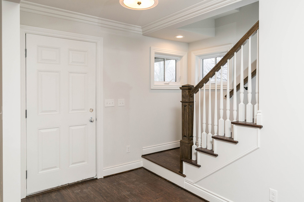Mid-sized traditional hallway in Detroit with white walls, dark hardwood floors and multi-coloured floor.