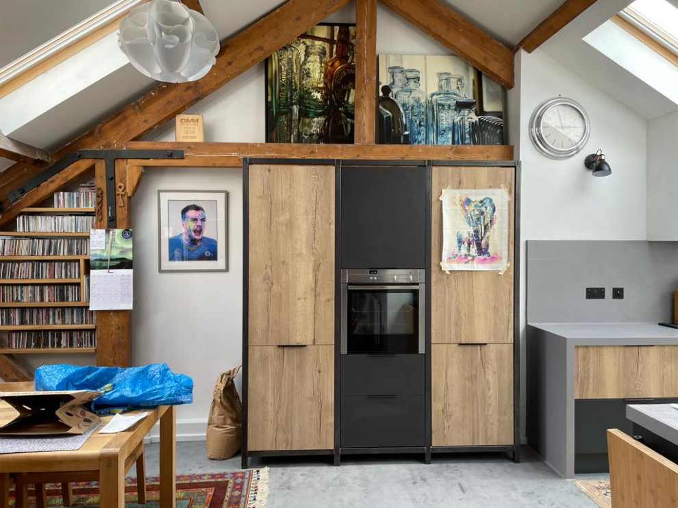 Design ideas for a small eclectic galley open plan kitchen with concrete flooring, no island, grey floors, grey worktops, exposed beams and feature lighting.