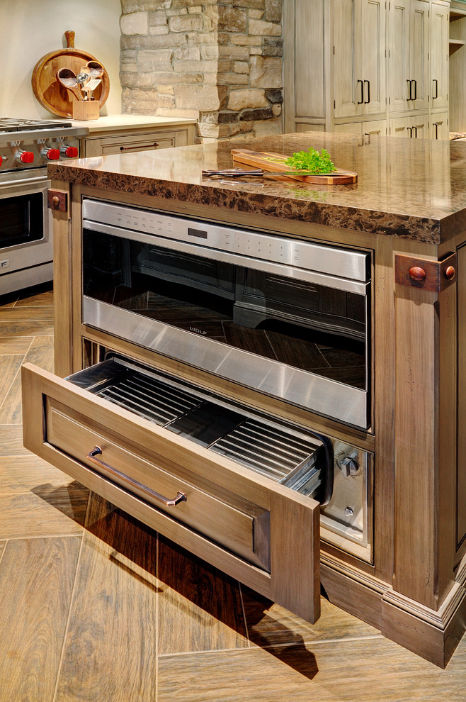 Eat-in kitchen - mid-sized transitional u-shaped porcelain tile eat-in kitchen idea in Toronto with an undermount sink, beaded inset cabinets, granite countertops, stainless steel appliances and an island
