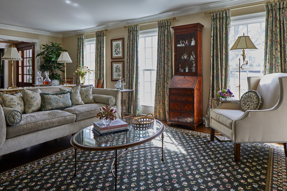 Traditional Rumson Home - This elongated living room was separated into three different seating arrangements with the largest upholstered sofa positioned centered of the space with a glass and metal console behind to visually divide the space.