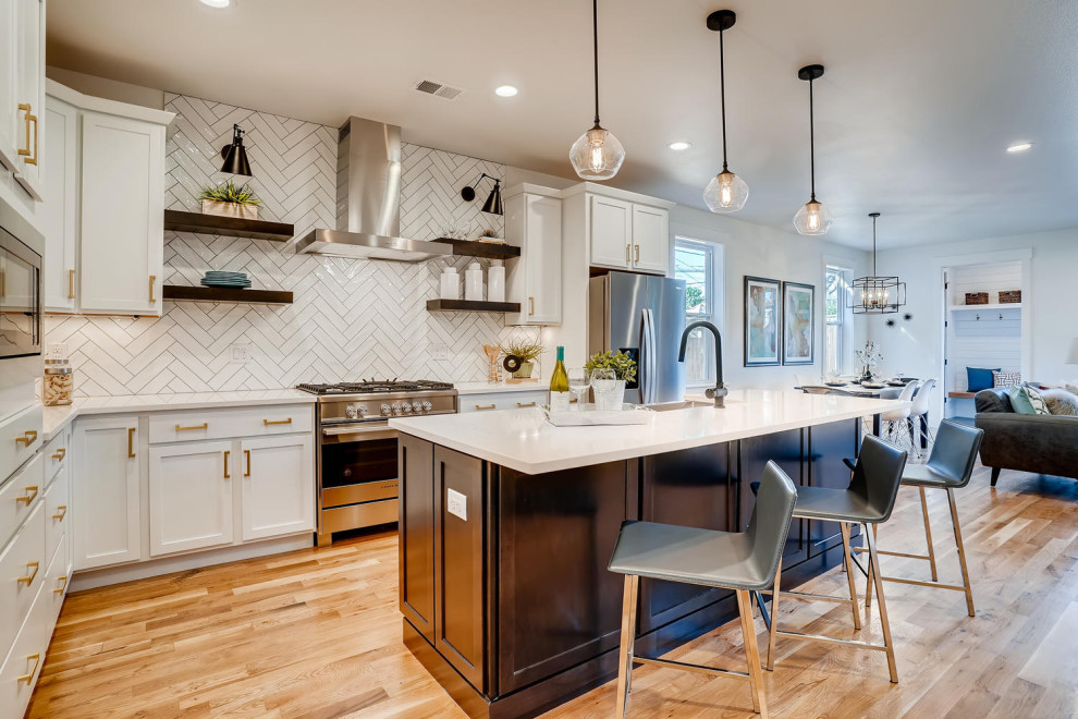 Inspiration for a mid-sized transitional medium tone wood floor eat-in kitchen remodel in Denver with a farmhouse sink, shaker cabinets, white cabinets, quartzite countertops, white backsplash, subway tile backsplash, stainless steel appliances, an island and white countertops