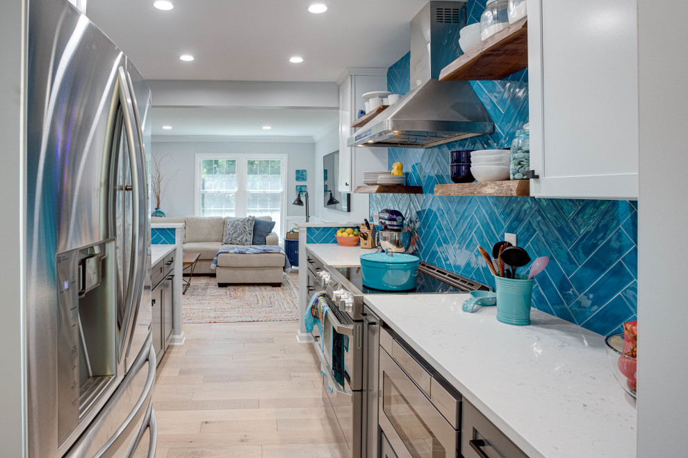 Kitchen - mid-sized transitional galley kitchen idea in DC Metro with an undermount sink, shaker cabinets, quartz countertops, blue backsplash, stainless steel appliances and no island
