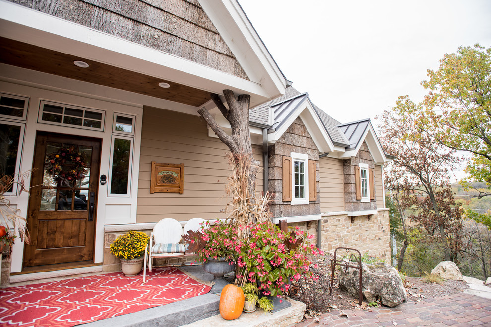 Front door - mid-sized rustic front door idea in Milwaukee with brown walls and a medium wood front door