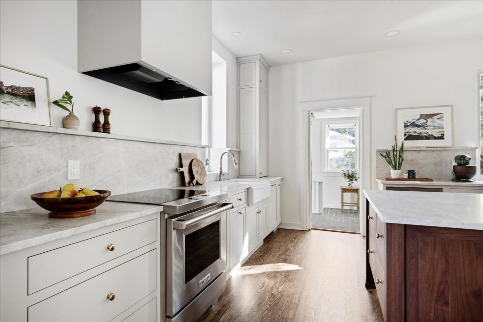 Inspiration for a mid-sized transitional medium tone wood floor and brown floor eat-in kitchen remodel in Denver with white walls and a standard fireplace