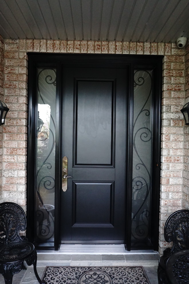 Example of a mid-sized transitional front door design in Toronto with a black front door