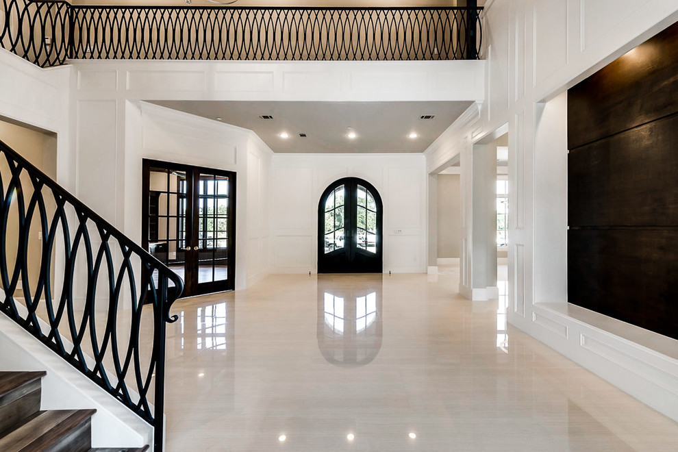 Photo of a large transitional foyer in Dallas with beige walls, porcelain floors, a double front door and a black front door.
