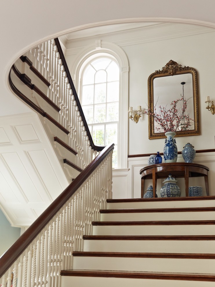 This is an example of a mid-sized traditional entry hall in New York with white walls, dark hardwood floors, a single front door and a white front door.