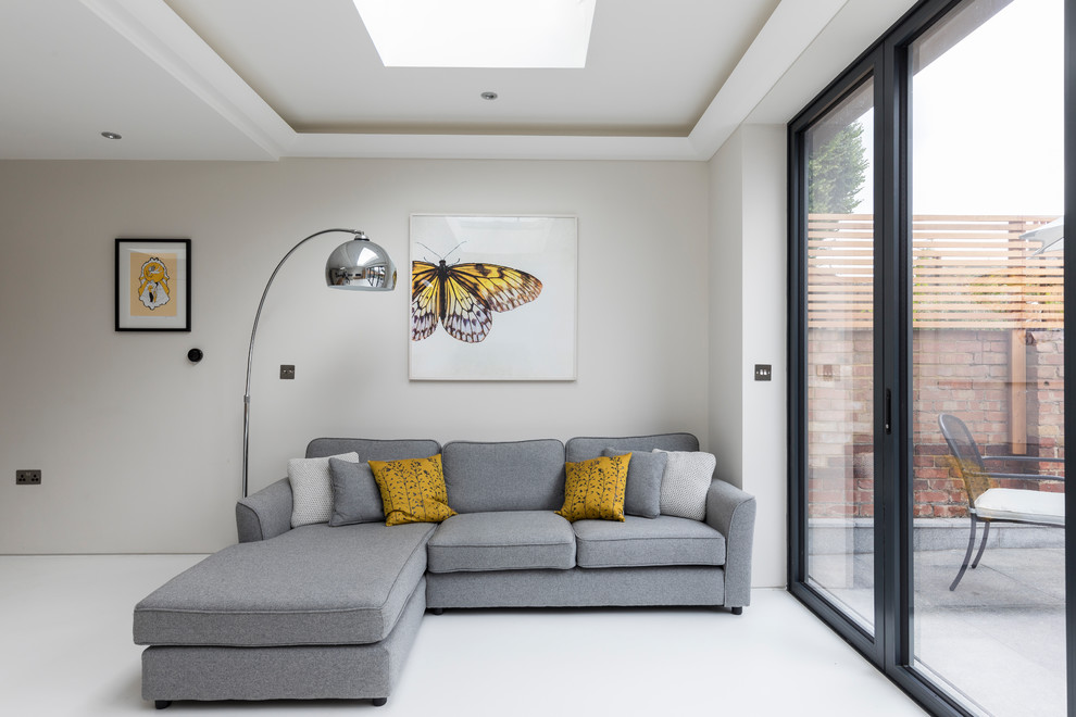 Photo of a mid-sized contemporary living room in London with white walls and white floor.