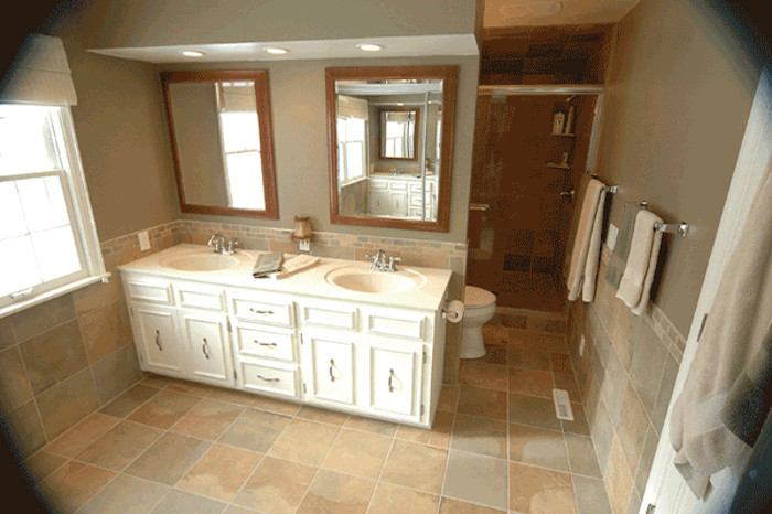 Design ideas for a traditional bathroom in Minneapolis with a drop-in sink, white cabinets, an alcove shower, brown tile, ceramic tile and ceramic floors.