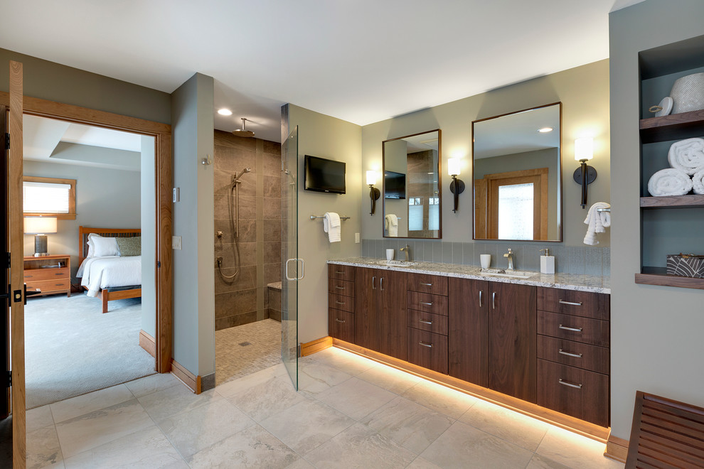 This is an example of a large transitional master bathroom in Minneapolis with flat-panel cabinets, medium wood cabinets, a freestanding tub, a curbless shower, grey walls, an undermount sink, granite benchtops, a one-piece toilet, gray tile, ceramic tile and ceramic floors.
