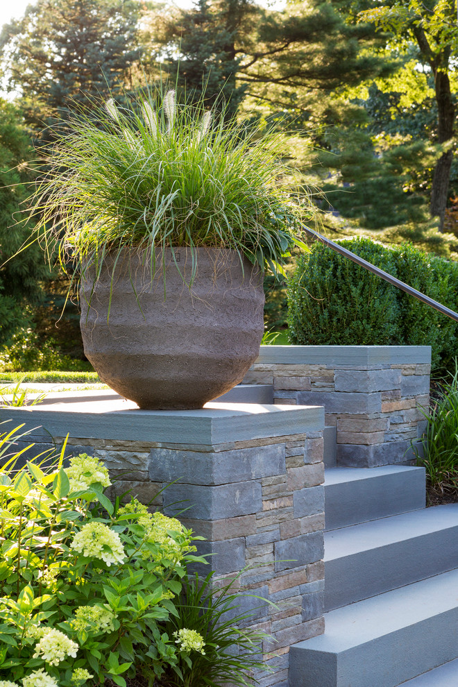 Design ideas for a contemporary front yard garden in Boston with natural stone pavers.