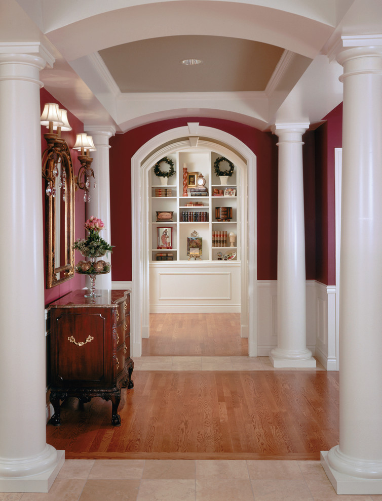 This is an example of a mid-sized traditional foyer in Seattle with red walls and light hardwood floors.