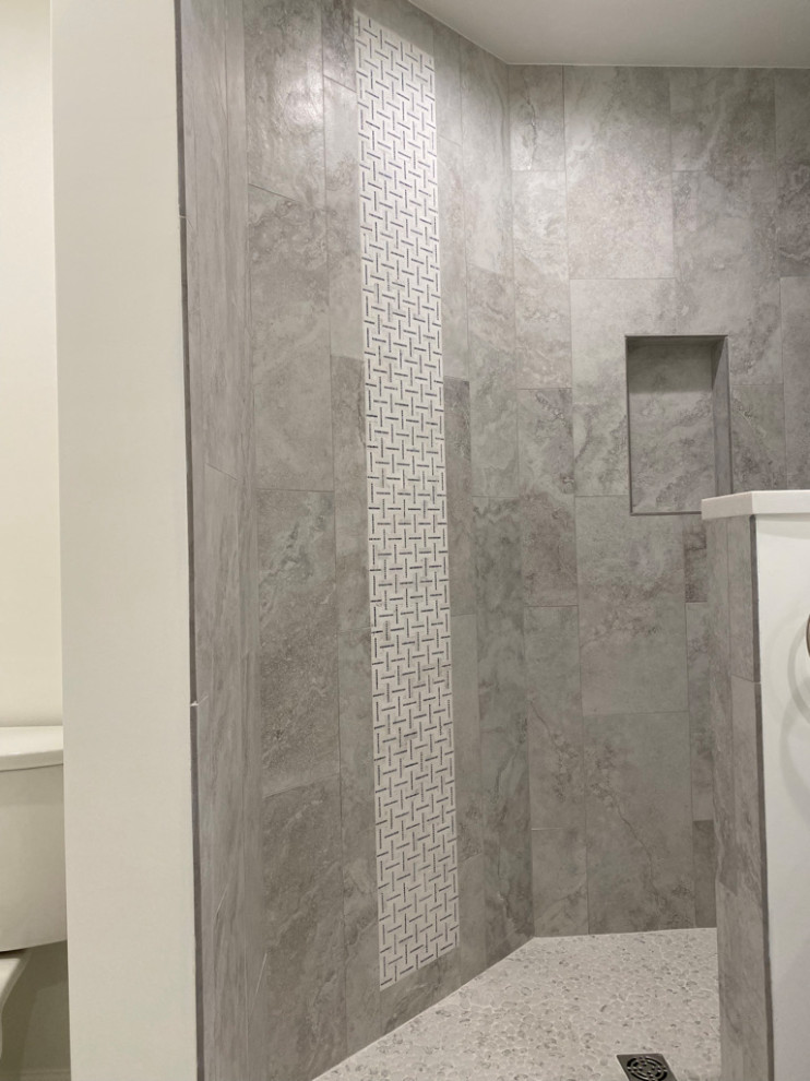 This is an example of a mid-sized contemporary bathroom in Bridgeport with shaker cabinets, blue cabinets, a corner shower, marble, white walls, porcelain floors, an undermount sink, engineered quartz benchtops, grey floor, white benchtops and a double vanity.