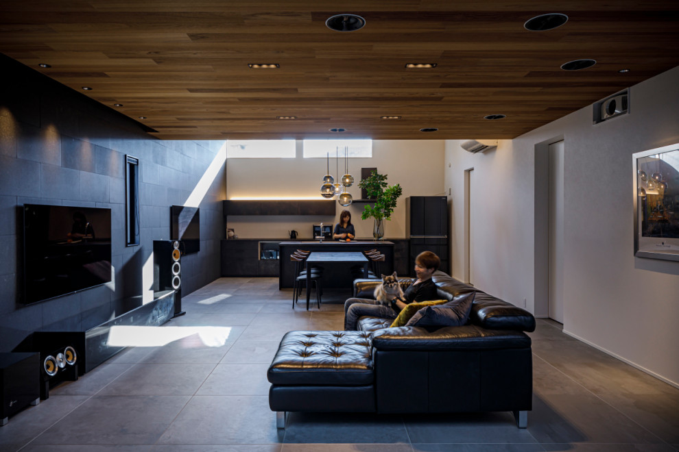 Large contemporary grey and brown open plan living room feature wall in Osaka with a music area, black walls, porcelain flooring, a wall mounted tv, grey floors and tongue and groove walls.