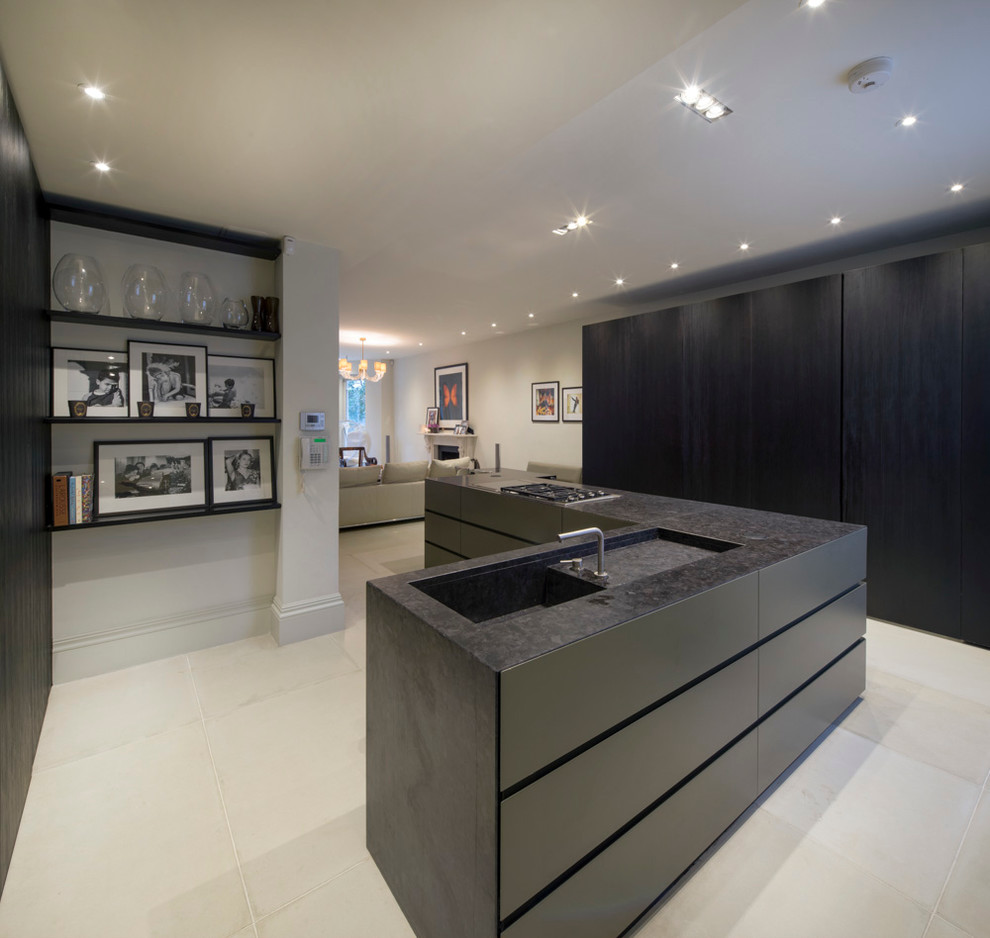 This is an example of a mid-sized contemporary u-shaped kitchen pantry in London with flat-panel cabinets, dark wood cabinets and onyx benchtops.