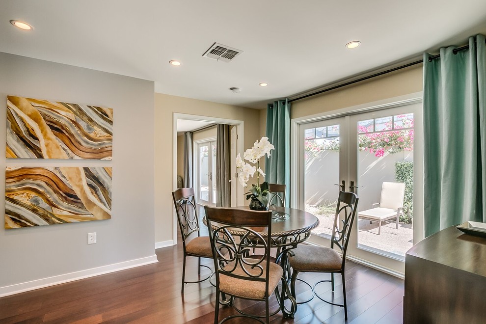 Dining room - mid-sized transitional medium tone wood floor and brown floor dining room idea in Phoenix with white walls and no fireplace