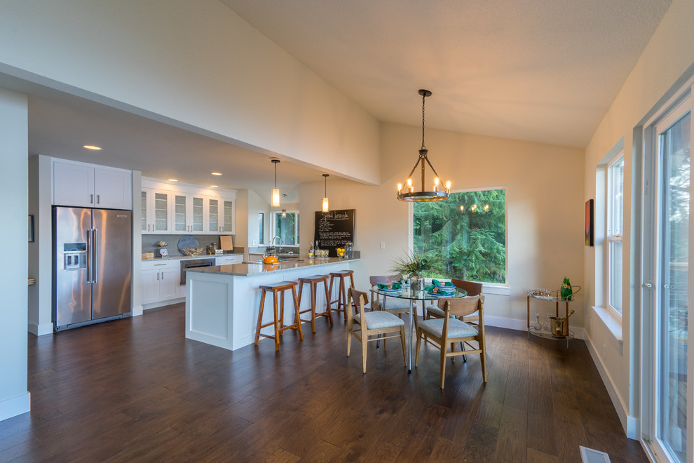 Photo of a large arts and crafts kitchen/dining combo in Seattle with white walls, medium hardwood floors and no fireplace.