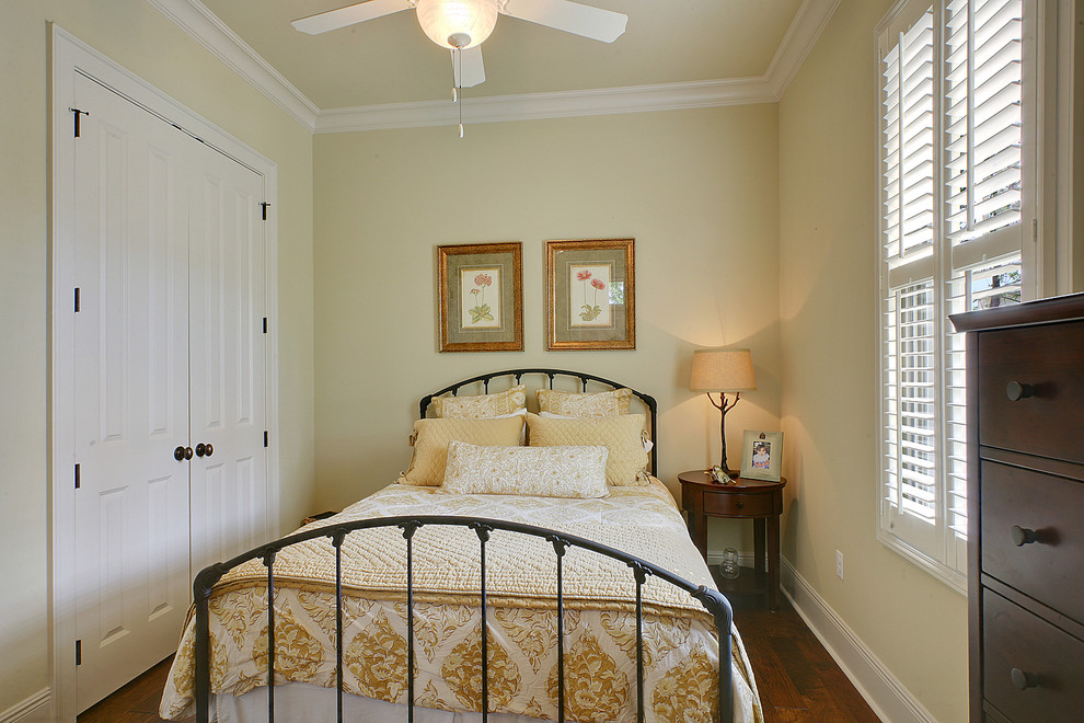 Design ideas for a traditional guest bedroom in New Orleans with yellow walls and dark hardwood floors.