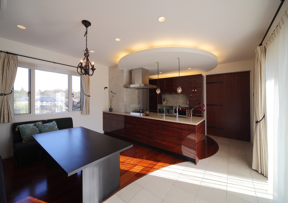 Mid-sized midcentury galley open plan kitchen in Tokyo Suburbs with an undermount sink, brown cabinets, solid surface benchtops, plywood floors, with island and brown floor.