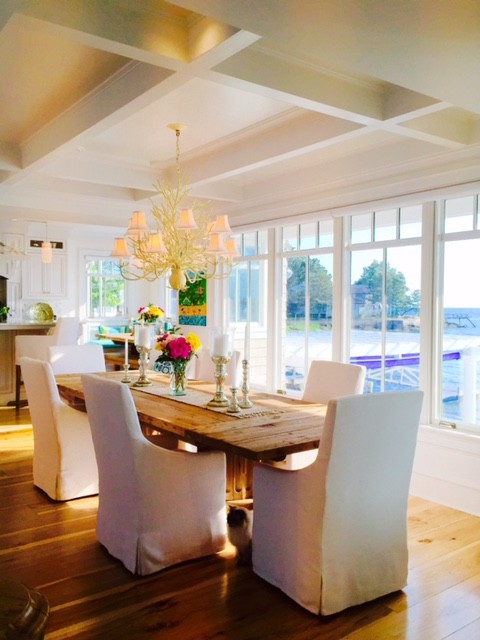 Photo of a large beach style kitchen/dining combo in New York with white walls and bamboo floors.