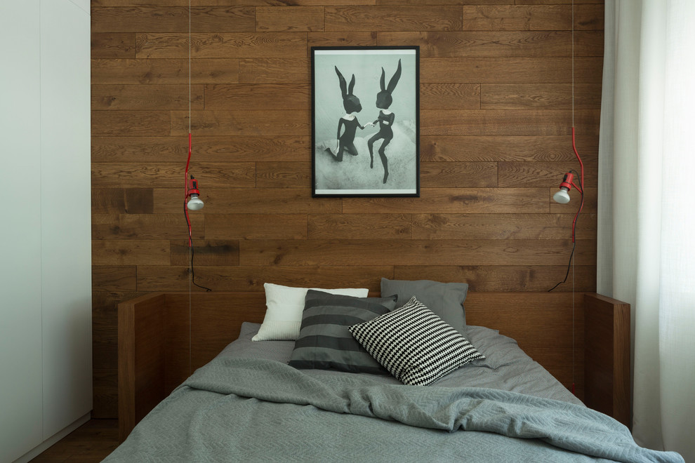 This is an example of a contemporary master bedroom in Moscow with brown walls.