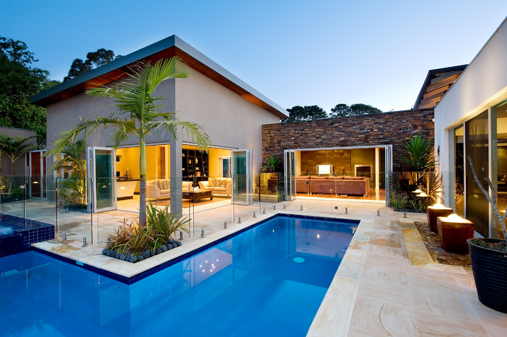 Inspiration for a mediterranean courtyard l-shaped pool in Melbourne with a hot tub.