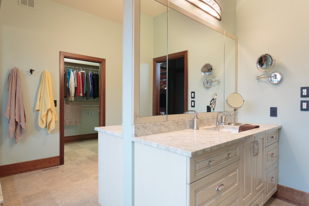 Photo of an expansive master bathroom in Other with beaded inset cabinets, white cabinets, a freestanding tub, granite benchtops, yellow benchtops, a corner shower, a wall-mount toilet, blue walls, porcelain floors, an undermount sink, beige floor, a hinged shower door, beige tile and porcelain tile.