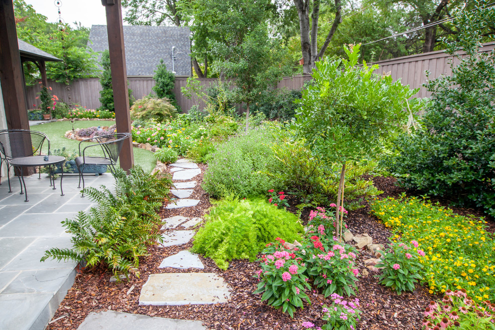 Photo of a large traditional partial sun backyard mulch formal garden in Dallas.